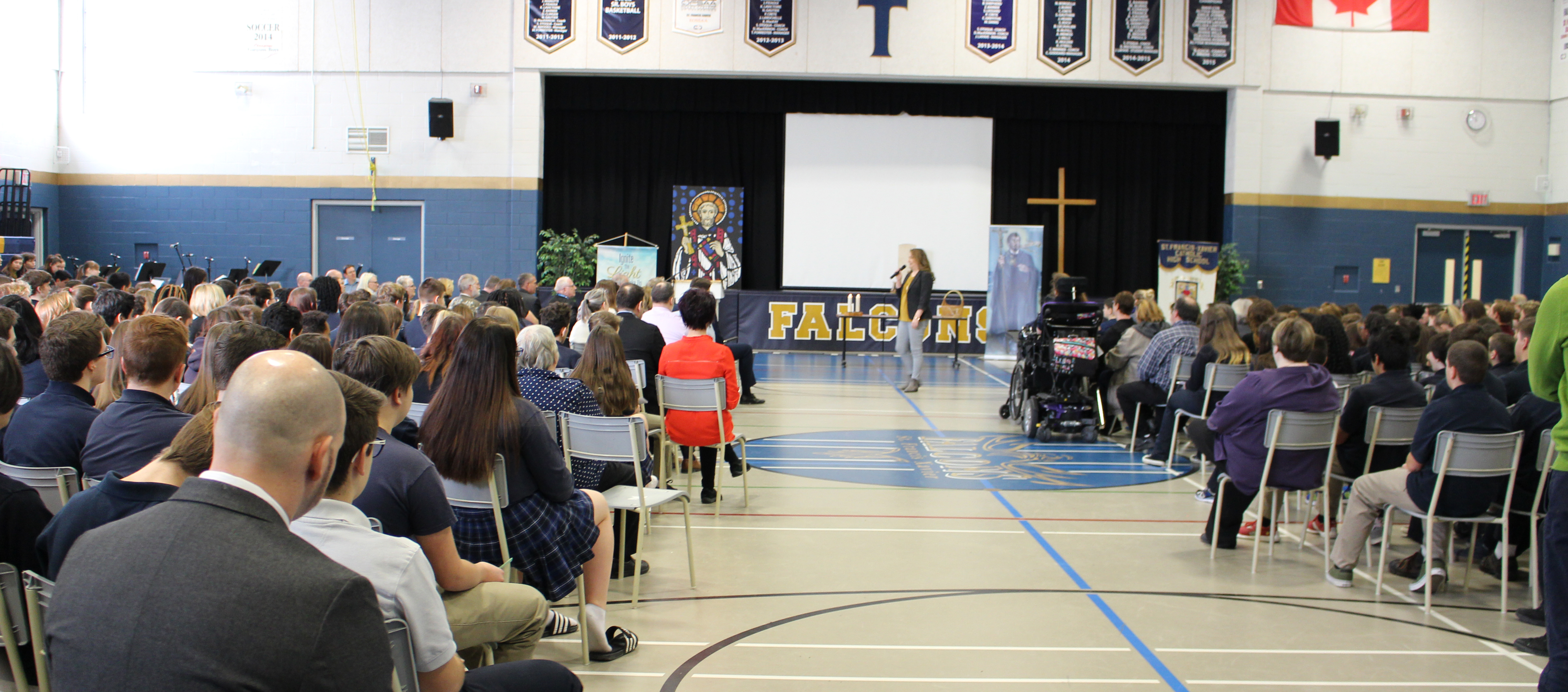 Long shot of Angèle Regnier addressing students at St. Francis Xavier CHS