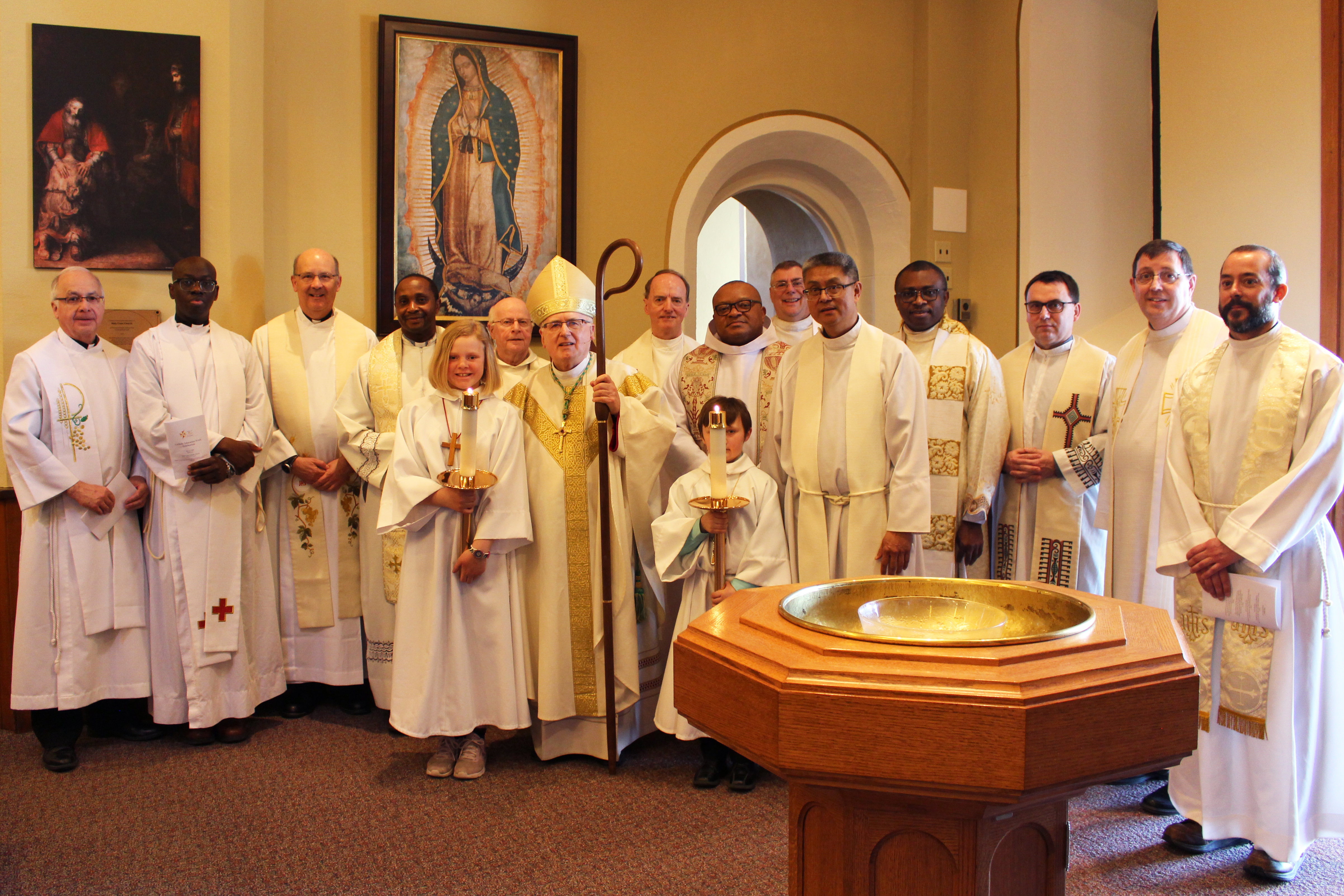 A group of clergy stand in a row at the CDSBEO board-wide mass.