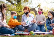 Students and teacher learning outside.