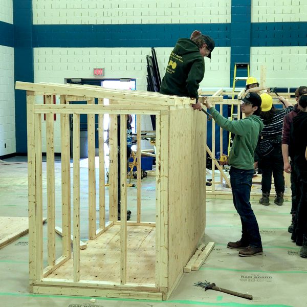 Students participating in the house building event.