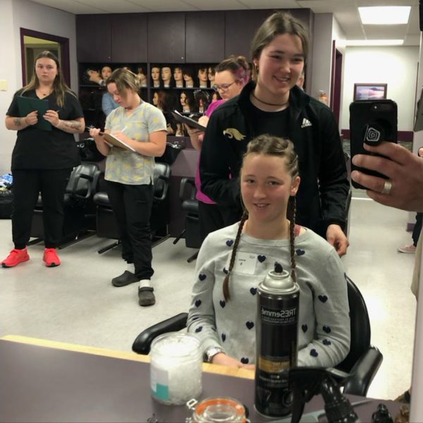 Students participating in the hair styling event.