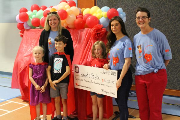 Photo of Nan Wehbe from the Heart & Stroke Foundation accepting a cheque from principal Paula Perrault and teacher Stephanie Brownlee, as well as the school’s top fundraisers Evelyn Berger, Maverick Topolnisky, and Elliot McNabb.