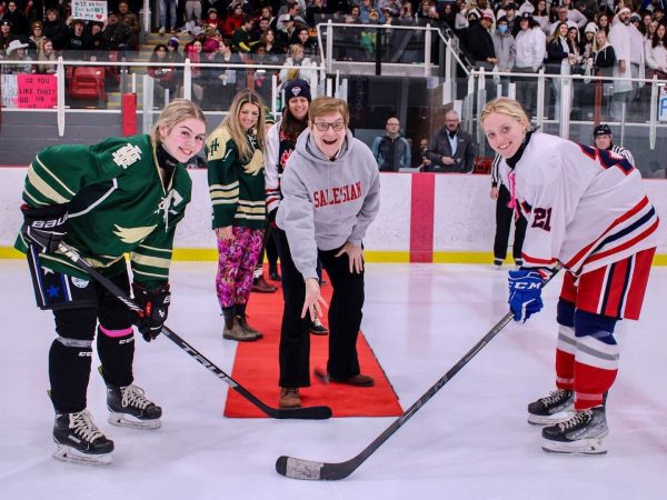 Hockey players face off for the 2022 Sisters' Cup game.