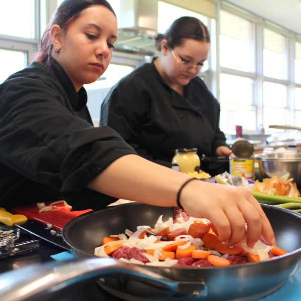 Students cooking at the 2023 culinary arts skills competition.