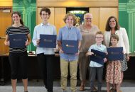 A group of students posing with their certificates at the CDSBEO Board Meeting.