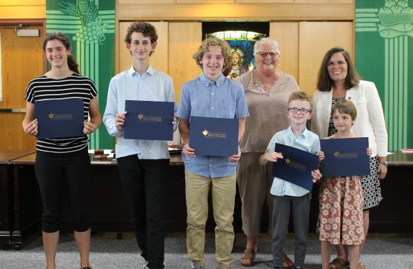 A group of students posing with their certificates at the CDSBEO Board Meeting.