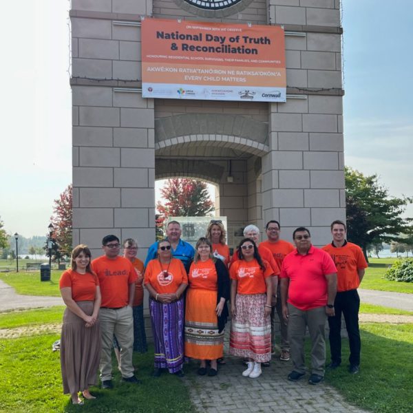 Representatives from the CDSBEO, Ahkwesahsne Mohawk Board of Education, Upper Canada District School Board, Mohawk Council of Akwesasne, and the City of Cornwall under the National Day of Truth and Reconciliation Banner in Cornwall.